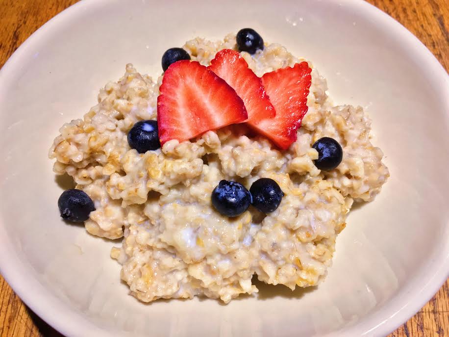 Bowl of Roadhouse steel-cut oatmeal with strawberries and blueberries.