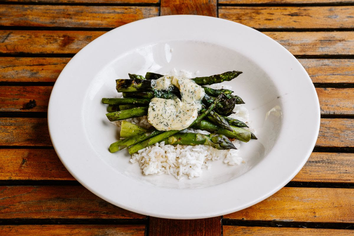 A plate with rice and grilled asparagus and tarragon butter