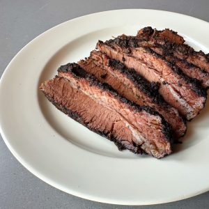 A plate of sliced smoked Texas brisket.