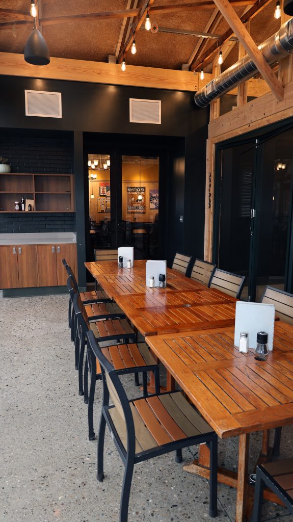 A photo of a long table in an enclosed patio space.