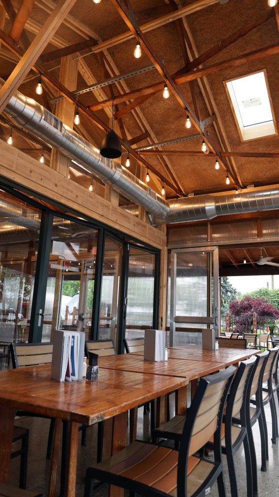 A photo of a long table in an enclosed patio space.