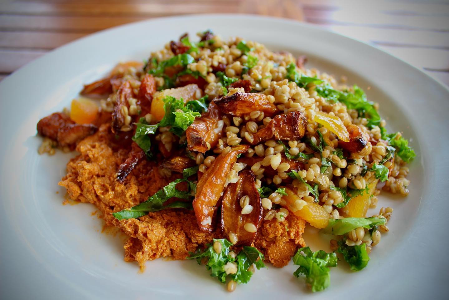 A dish of carrots, couscous, and whipped feta.
