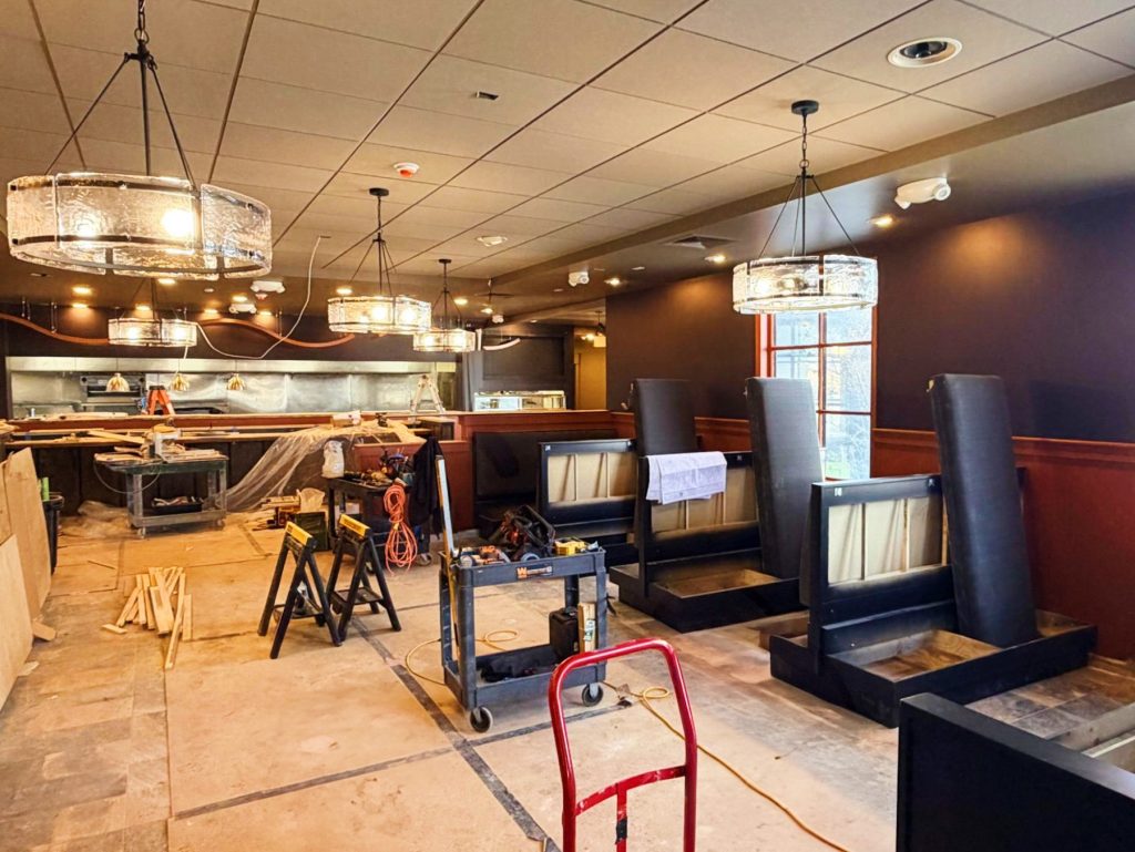 A dining r
oom under construction with fresh paint and new booths.