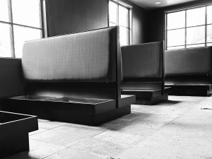 A black and white photo of a dining room with new booths.