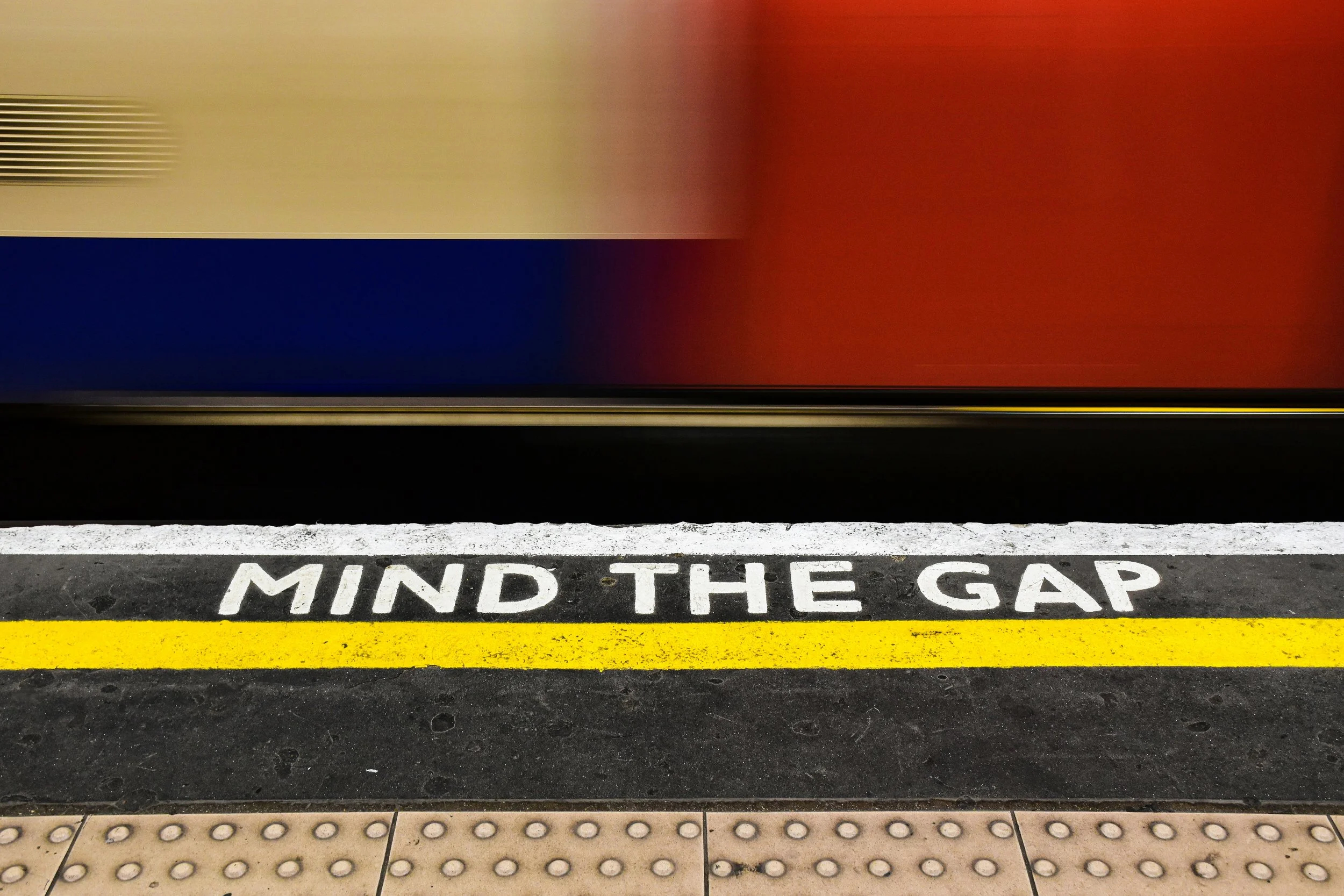 A subway track with the cautionary message to "Mind the gap"