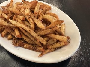 A plate full of spiced fries