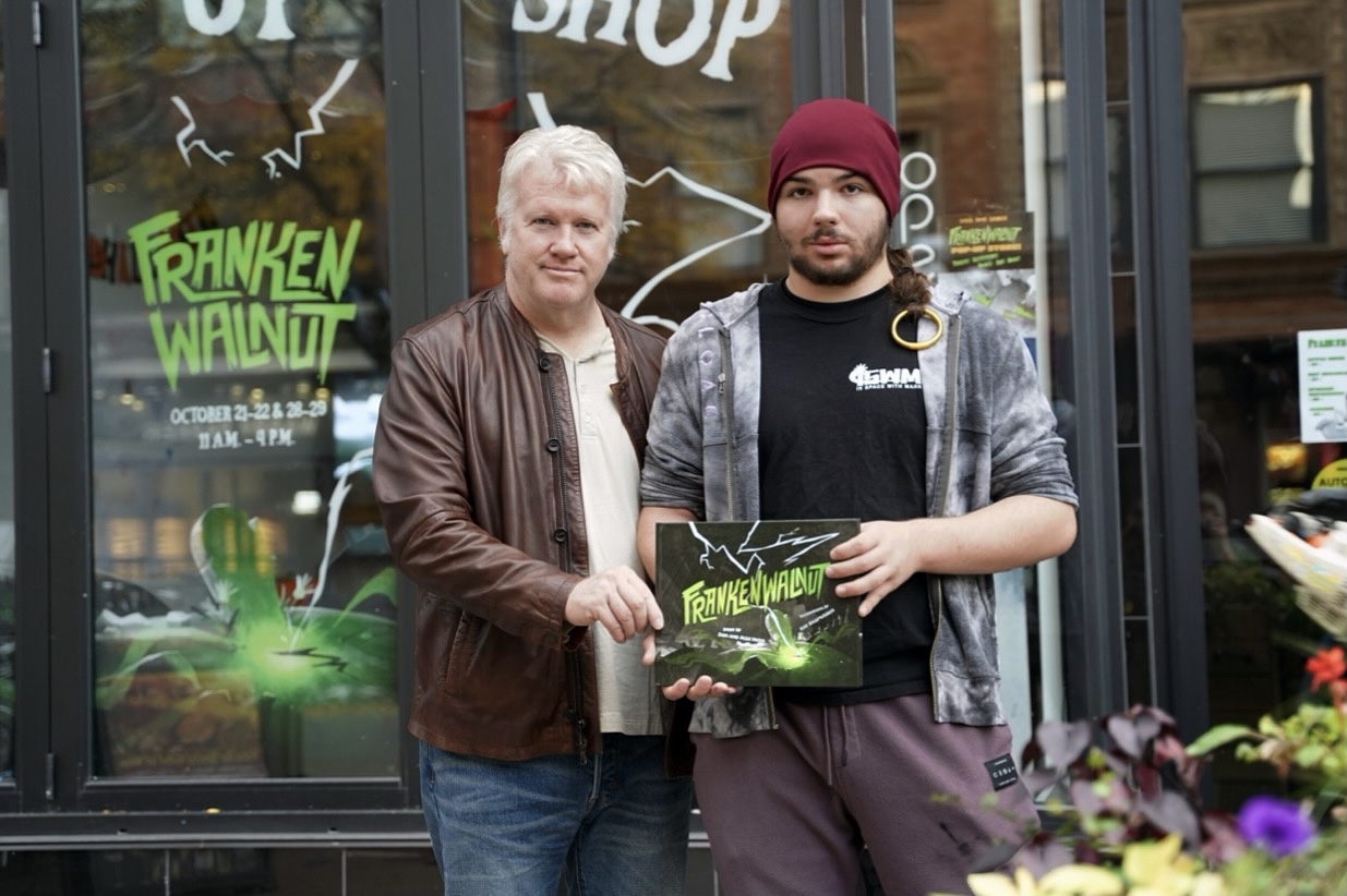 Authors Don and Alex Hicks holding up their children's book Frankenwalnut.