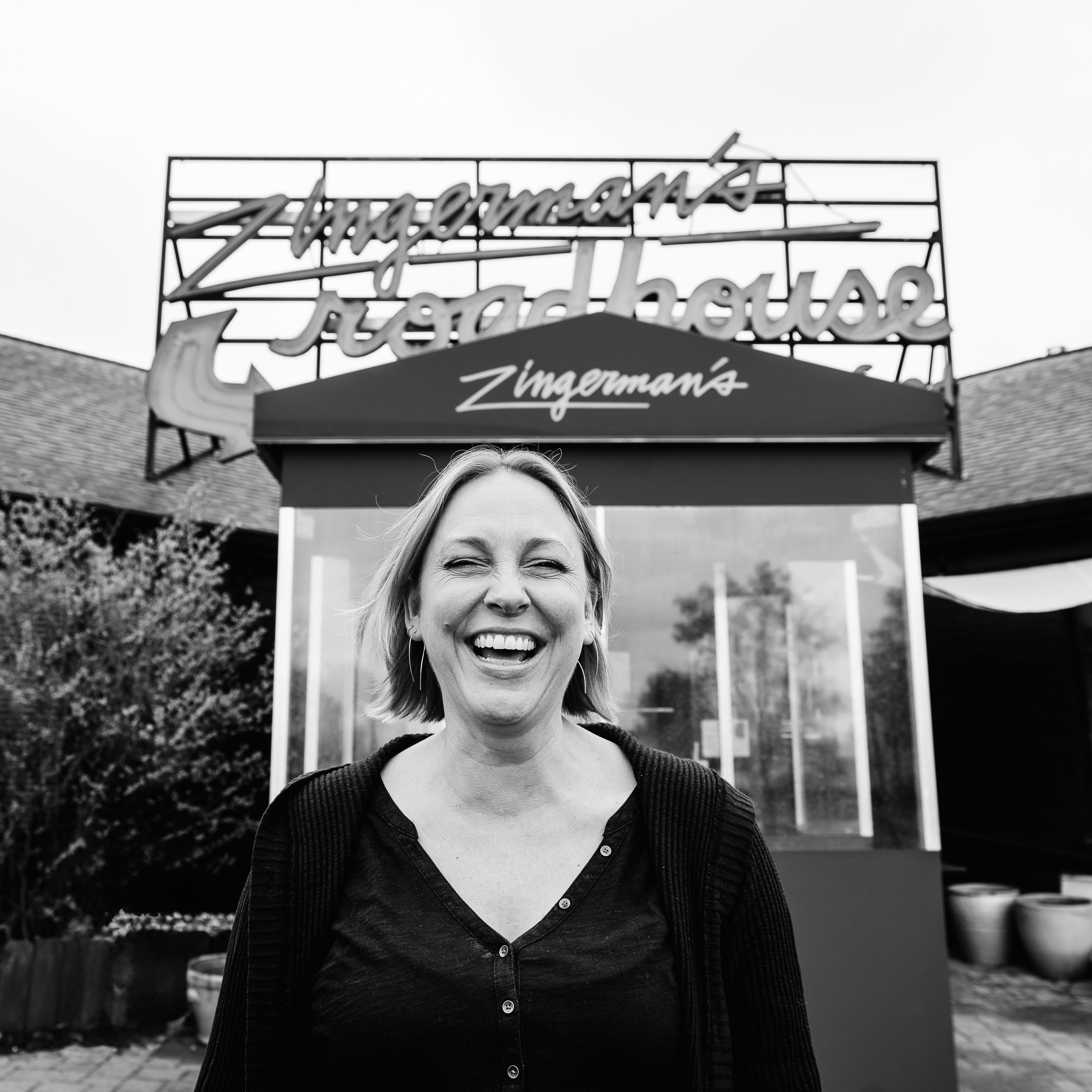 Managing Partner, Lisa Schultz, standing in front of Zingerman's Roadhouse smiling.