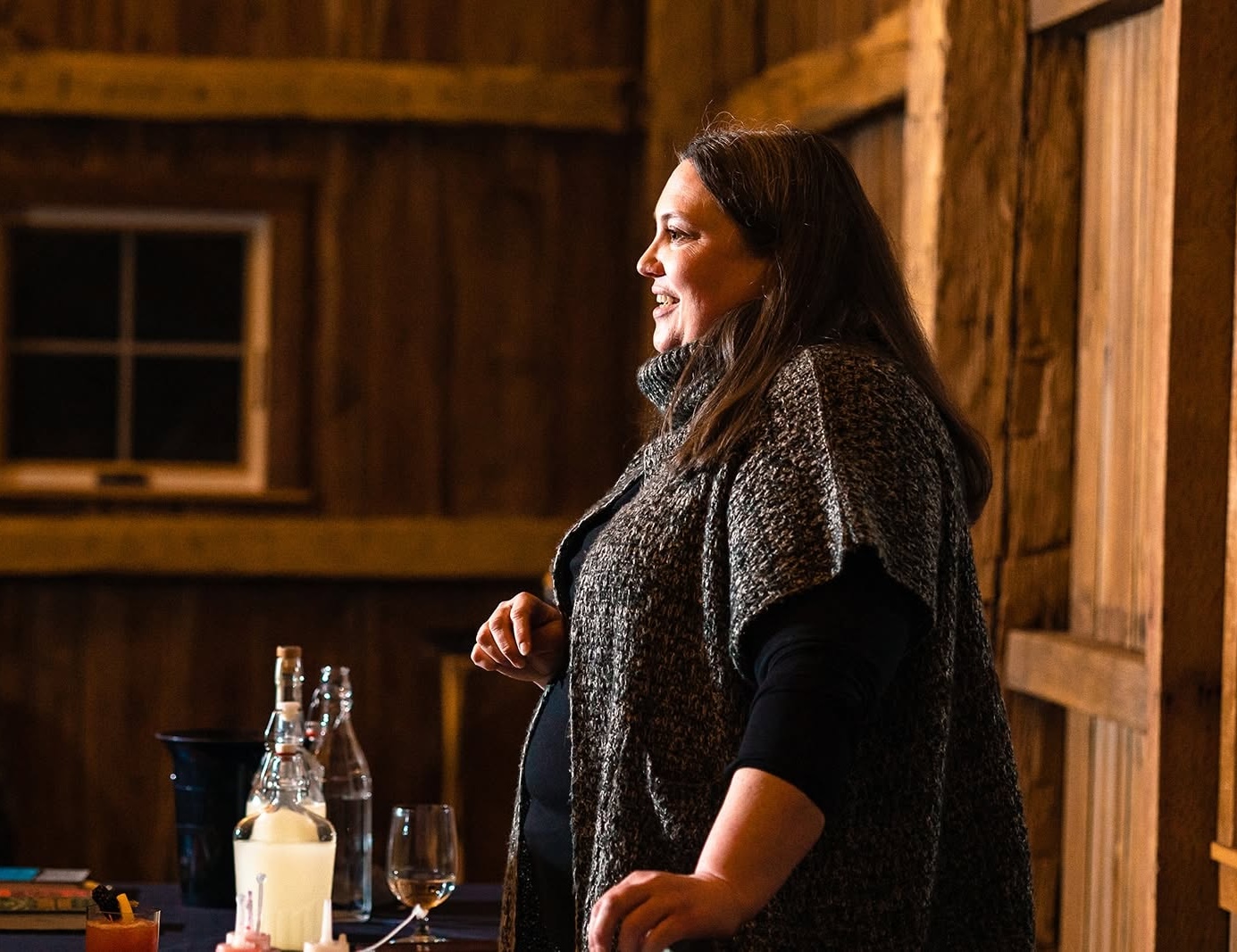 A photo of Beth Vandergrift from Liquor & Lore co. teaching a cocktail class.